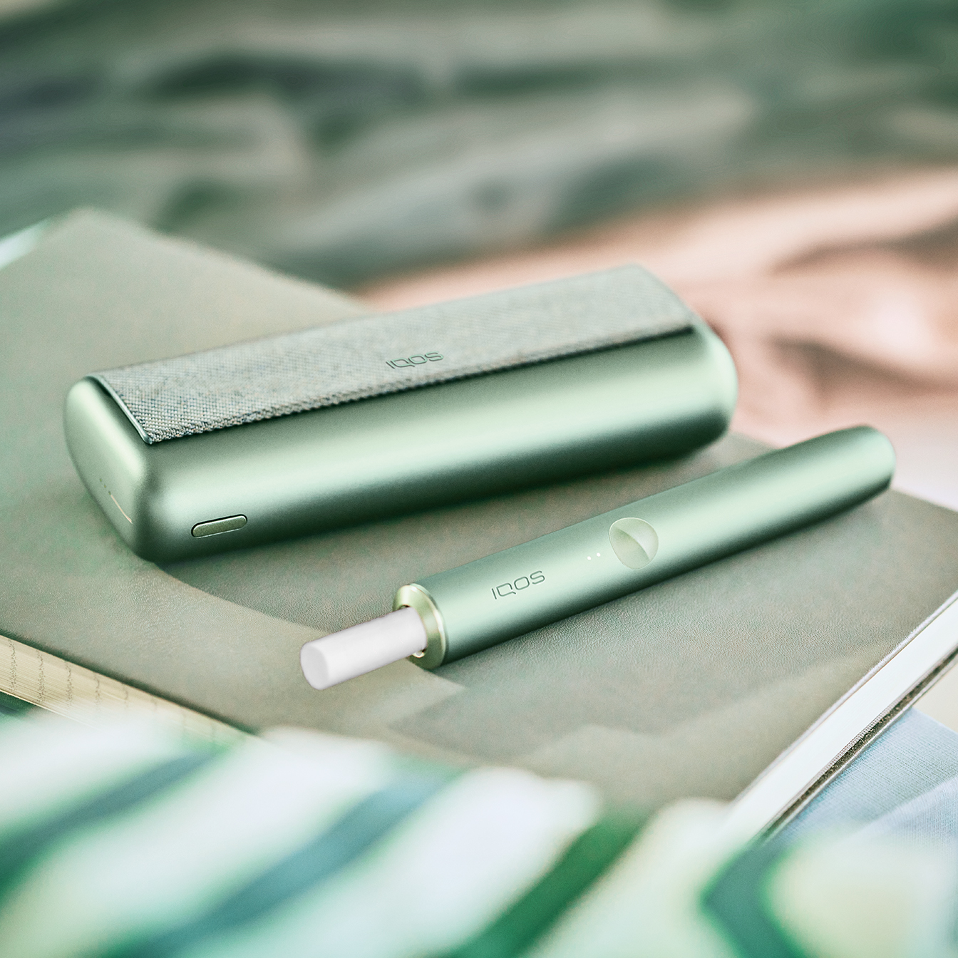 An IQOS Holder and Pocket Charger on a side table.