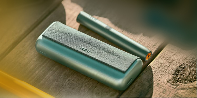 A jade green IQOS ILUMA PRIME Pocket Charger and Holder.