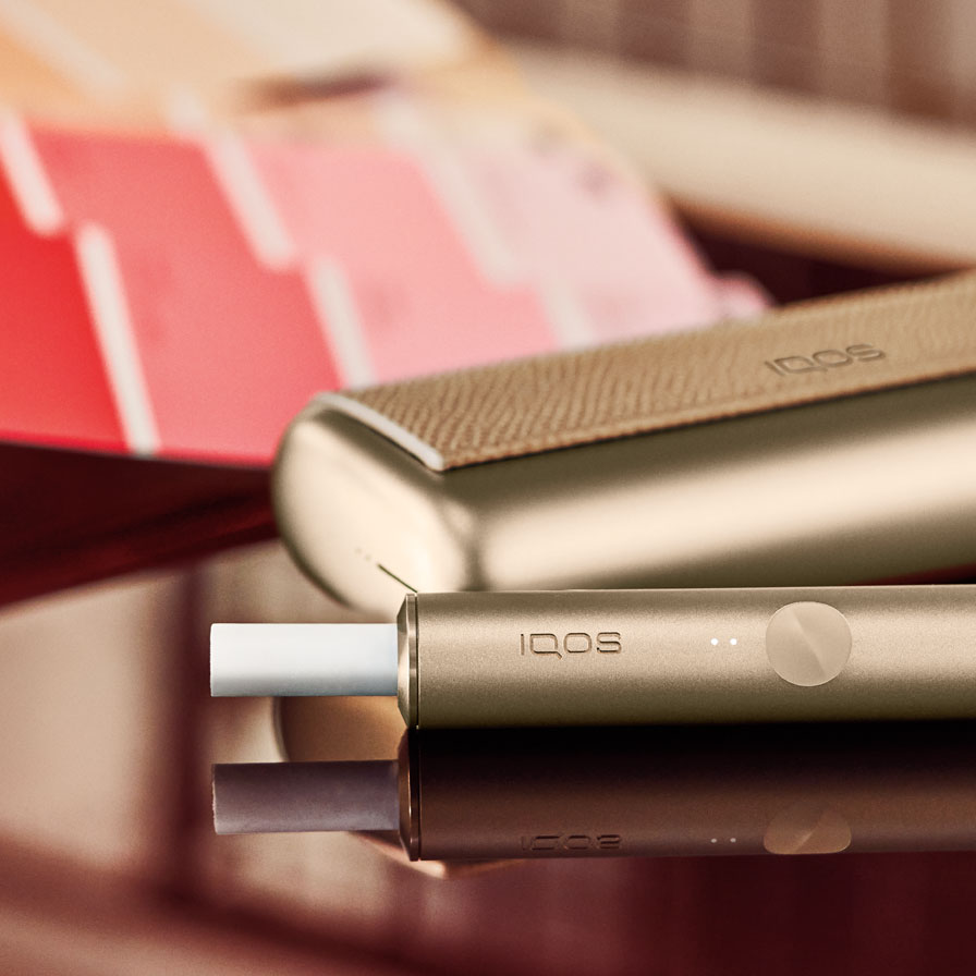 An IQOS ILUMA device on a table.