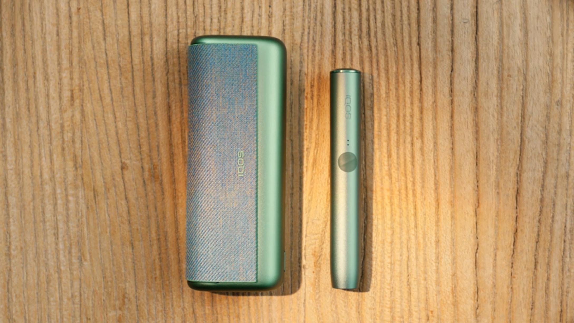 A Jade Green IQOS ILUMA PRIME Pocket Charger and Holder.