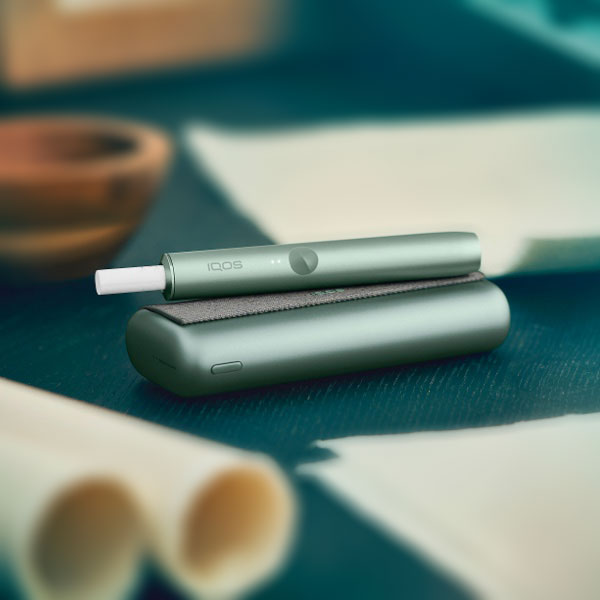 An IQOS ILUMA device on a table.