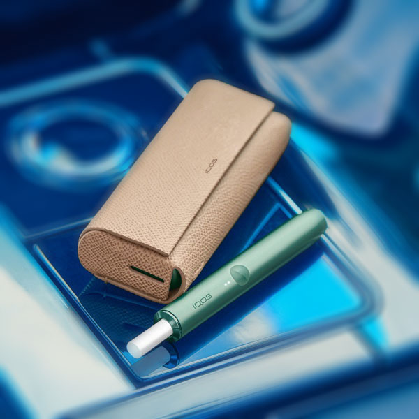 A Moss Green IQOS ILUMA device.