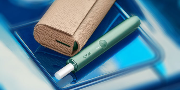 A Moss Green IQOS ILUMA device.