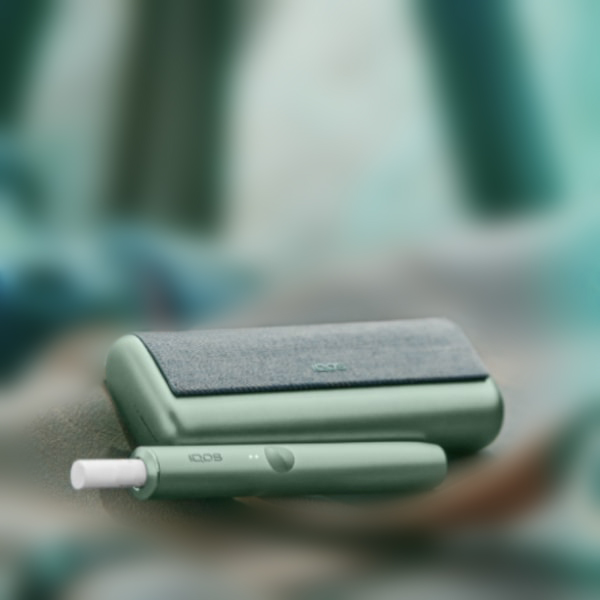 A Jade Green IQOS ILUMA PRIME Holder and Charger.