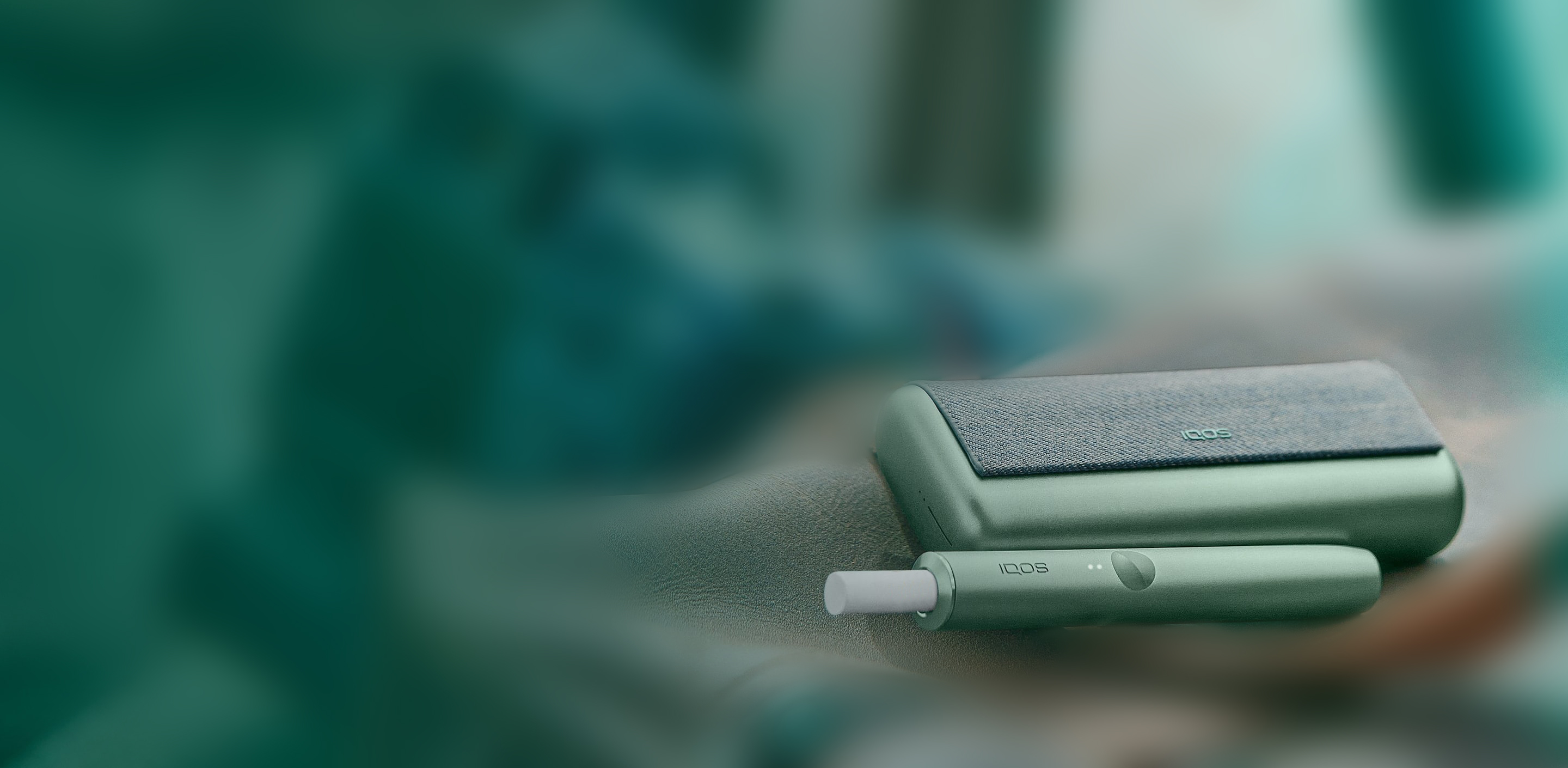 A Jade Green IQOS ILUMA PRIME Pocket Charger and Holder.